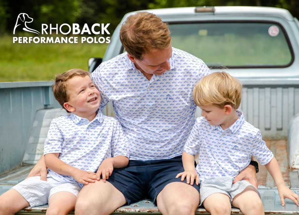 Father with two young sons in matching shirts on the back of a truck on  postcard advertising